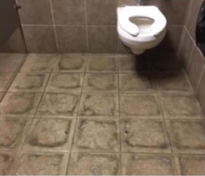 Bathroom in a business with dirty tile